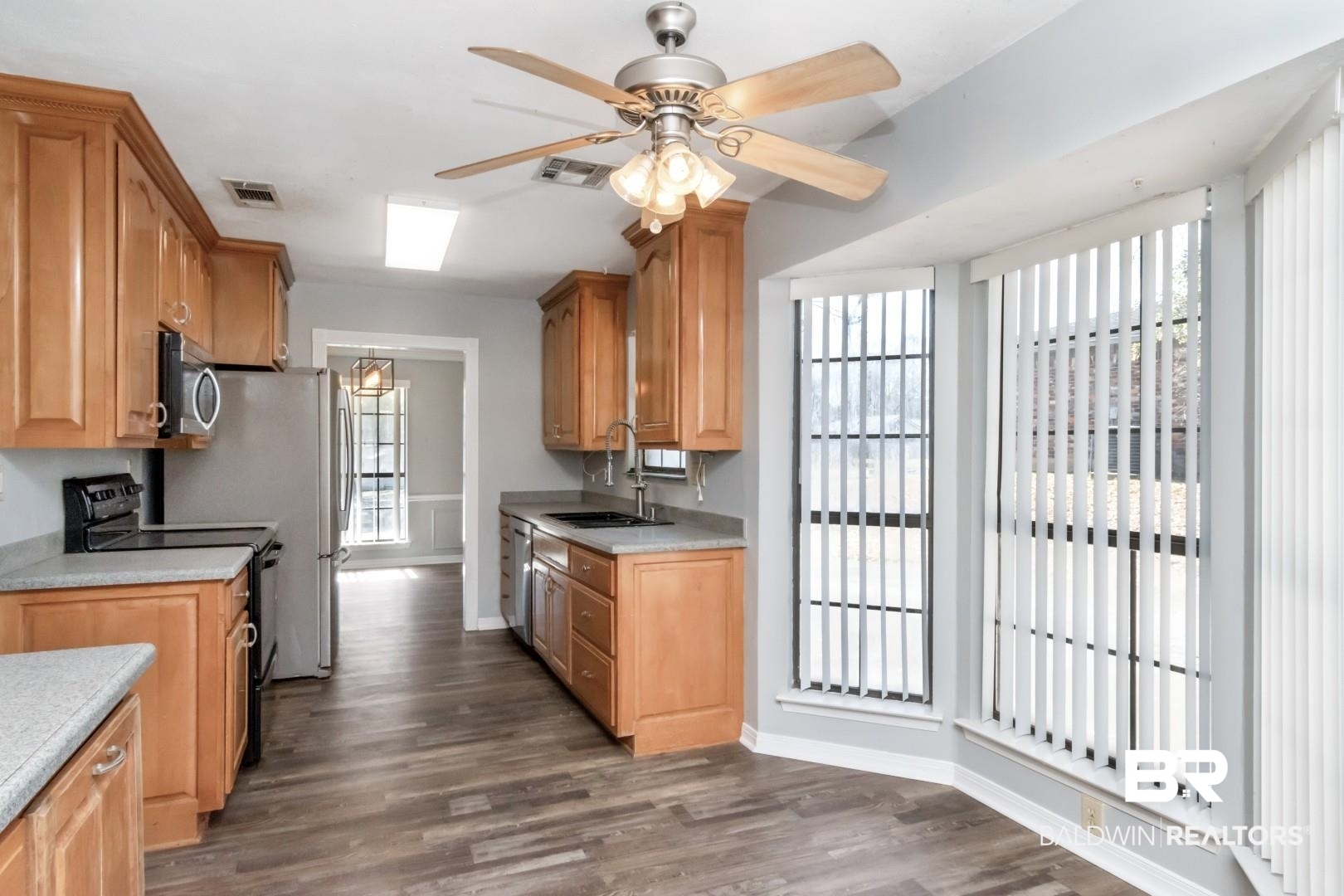 8304 Champlain Circle Mobile, AL 36695 - Photo 12 of 46 Kitchen with appliances with stainless steel finishes, sink, dark wood-type flooring, and plenty of natural light