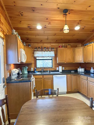 a kitchen with a wooden floor and cabinets