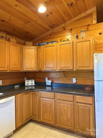 a kitchen with granite countertop a sink and cabinets