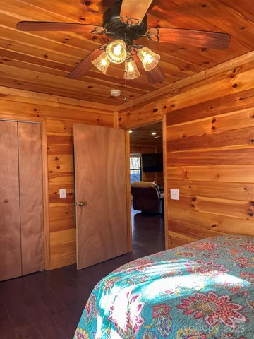 a bedroom with a bed and a chandelier