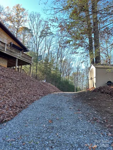 a view of a house with a yard and tree