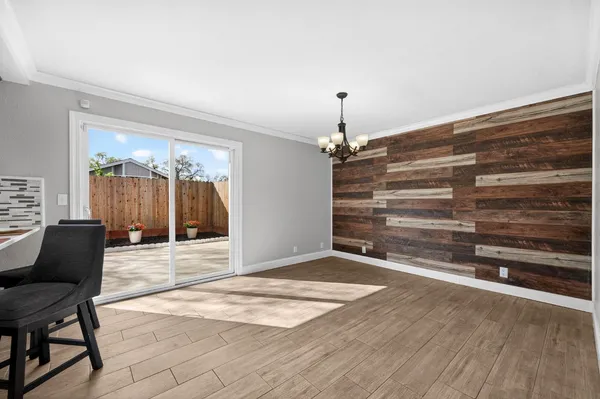a view of a livingroom with wooden floor and furniture