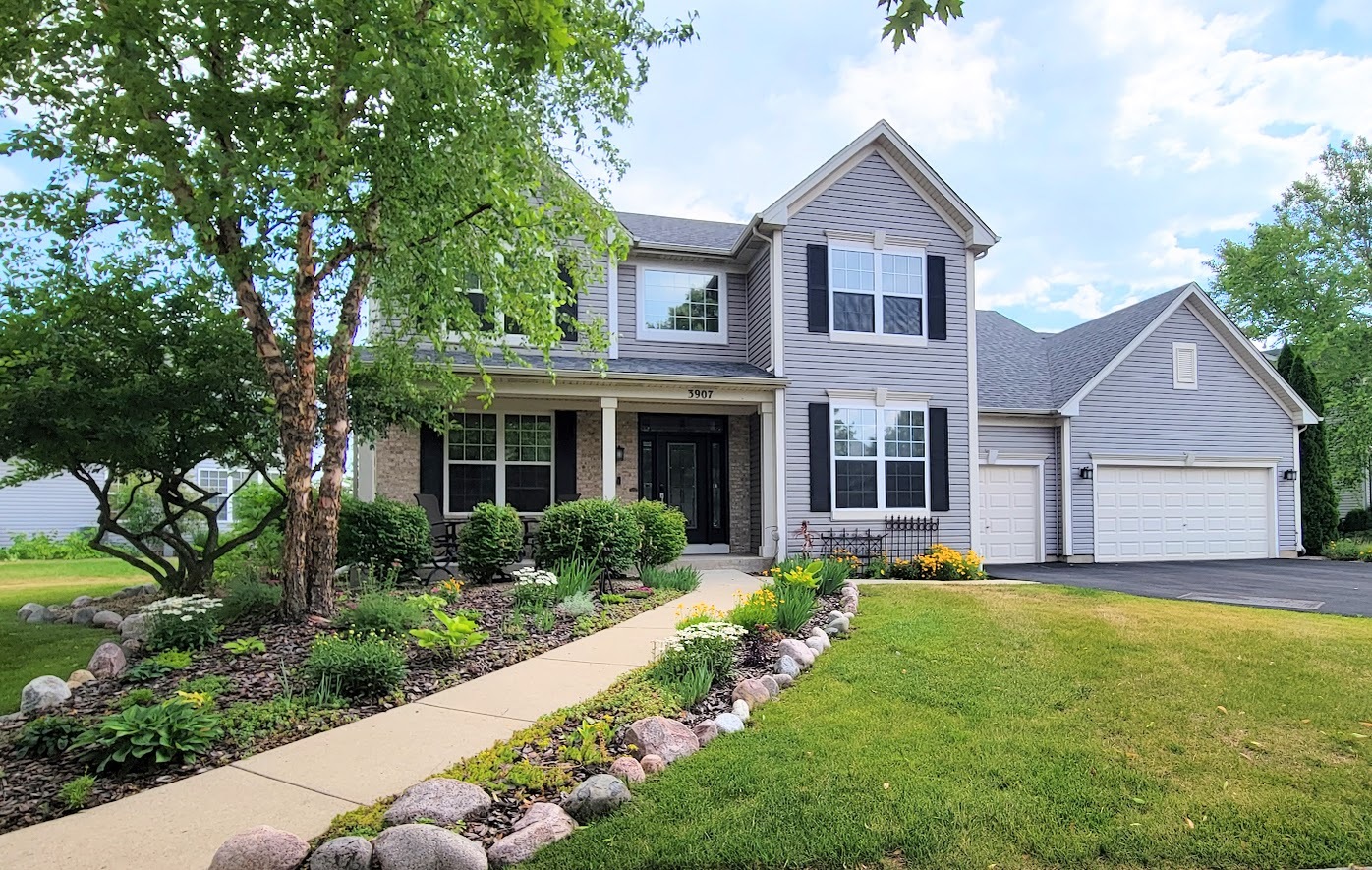 a front view of a house with a yard and porch