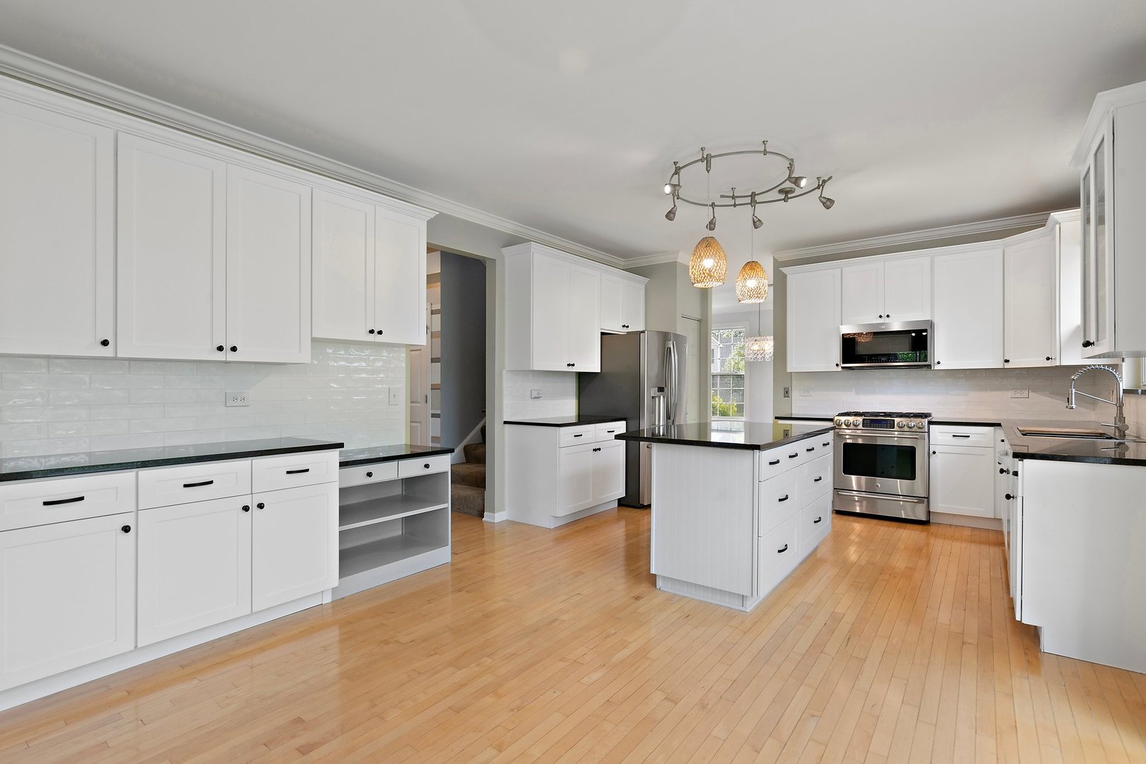 3907 Farmstead Road Carpentersville, IL 60110 - Photo 18 of 49 a kitchen with granite countertop a refrigerator oven a sink dishwasher and white cabinets with wooden floor