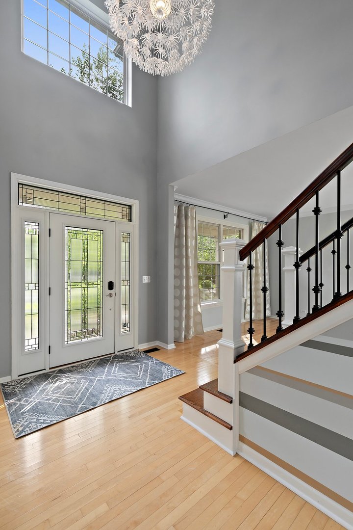 3907 Farmstead Road Carpentersville, IL 60110 - Photo 7 of 49 a view of an empty room with wooden floor and a window