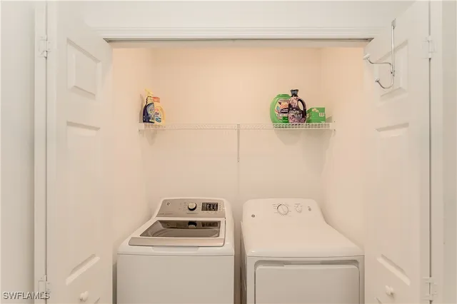 a view of storage and utility room with washer and dryer