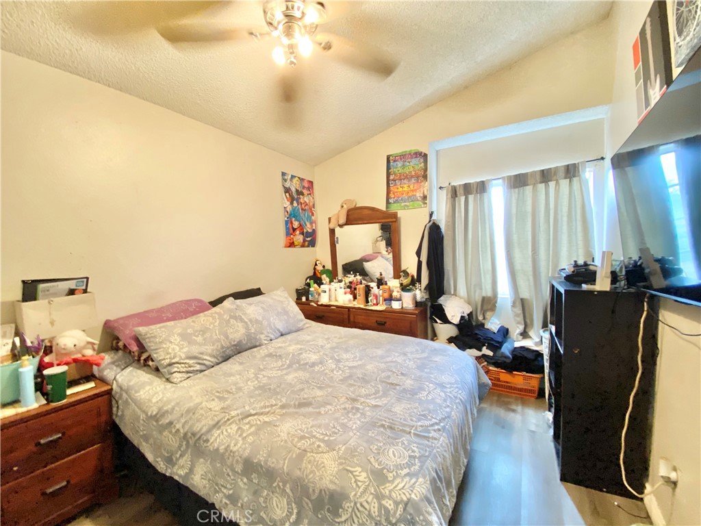 1444 North Sage Avenue Rialto, CA 92376 - Photo 18 of 22 a bedroom with a bed and wooden floor
