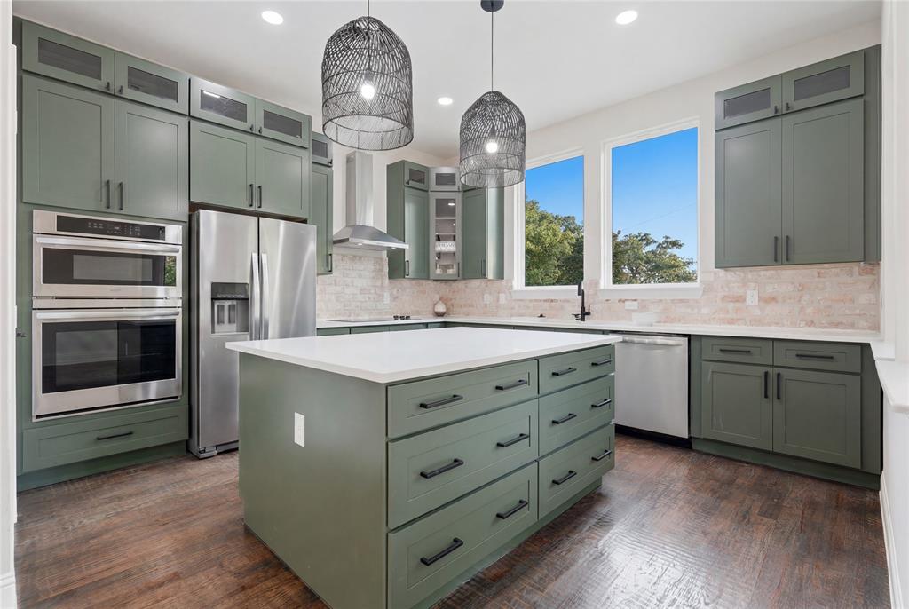 2150 Lakeview Mabank, TX 75156 - Photo 11 of 36 a kitchen with stainless steel appliances a sink cabinets and wooden floor