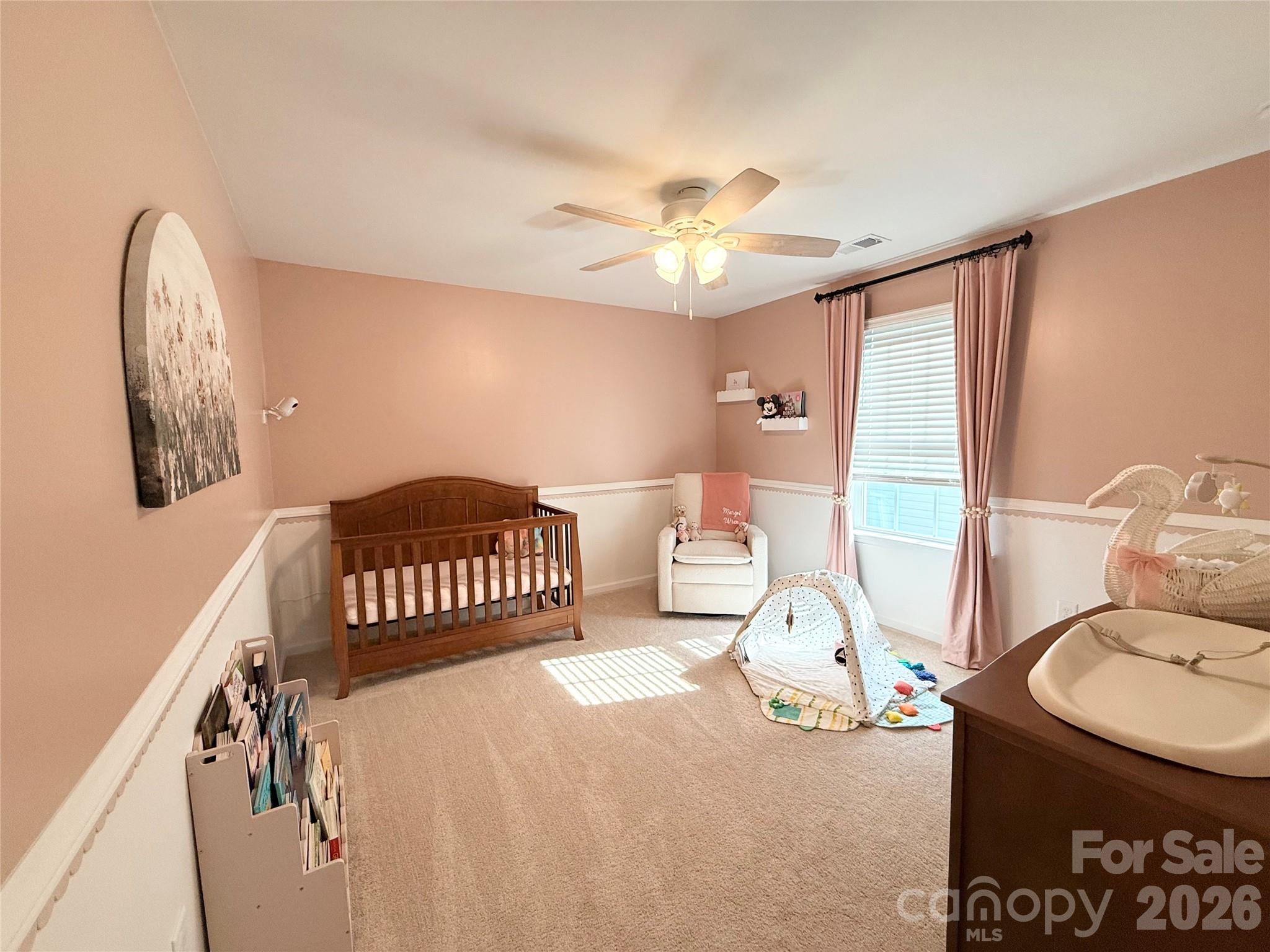 6570 Gopher Road Lancaster, SC 29720 - Photo 20 of 26 a bedroom with a bed and a chandelier