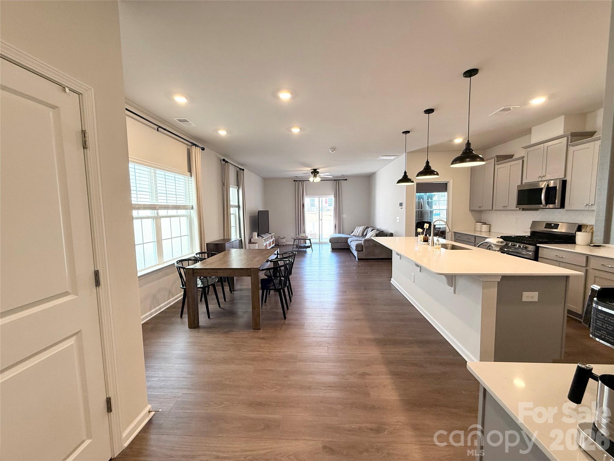 6570 Gopher Road Lancaster, SC 29720 - Photo 4 of 26 a large white kitchen with lots of counter space dining table and chairs