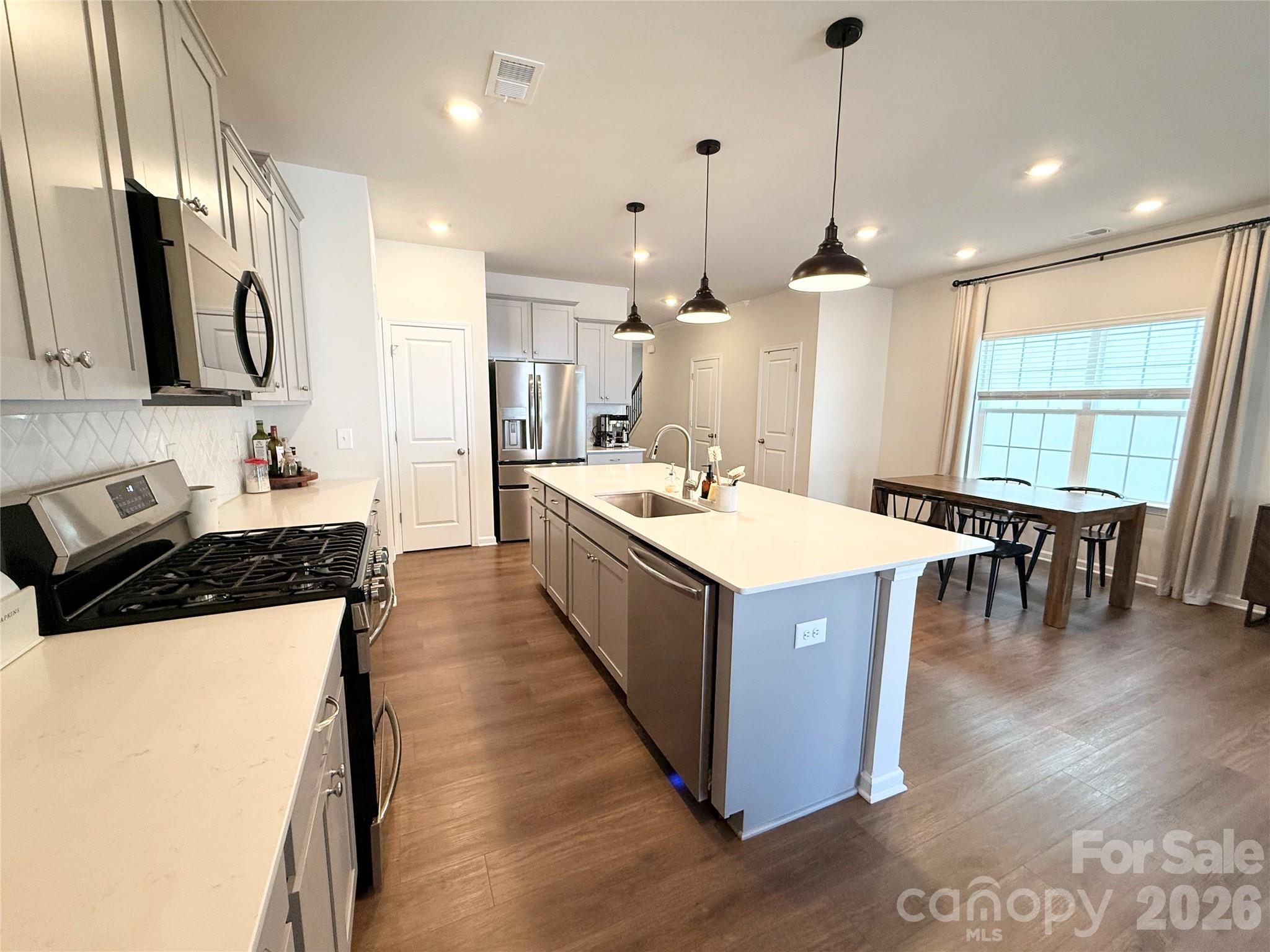 6570 Gopher Road Lancaster, SC 29720 - Photo 8 of 26 a large kitchen with stainless steel appliances a large center island attached withe living room