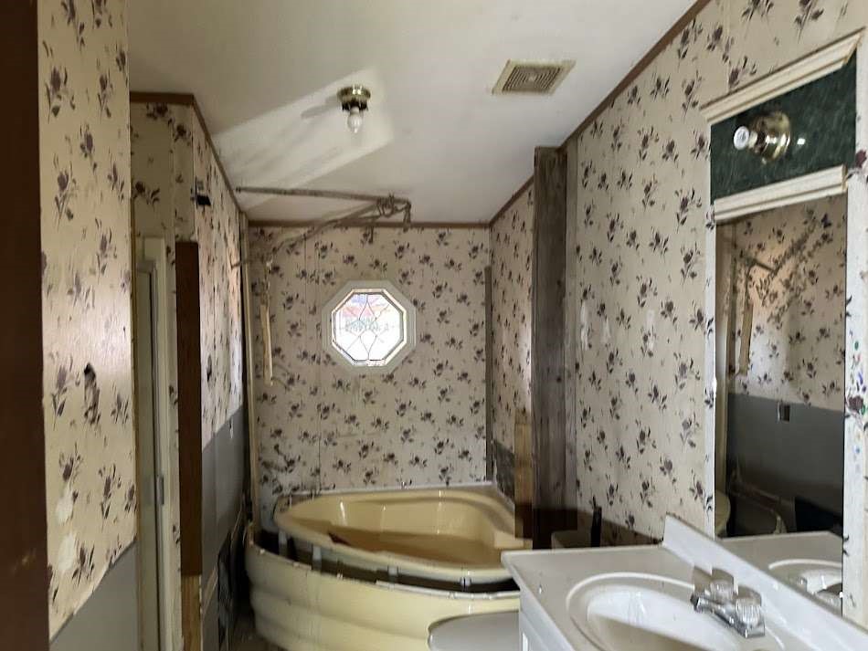 110 Bell Street Bangs, TX 76823 - Photo 6 of 10 a bathroom with a sink a toilet and shower curtain