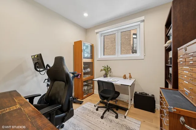 a view of a workspace with furniture and a window