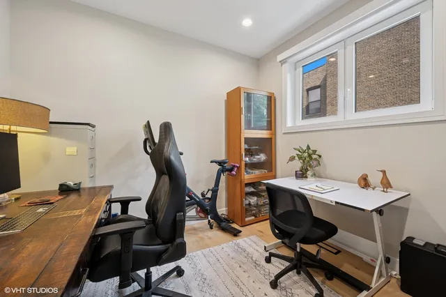 a view of a workspace with furniture and a window