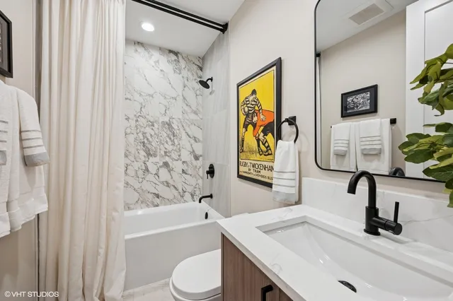 a bathroom with a sink mirror toilet and bathtub