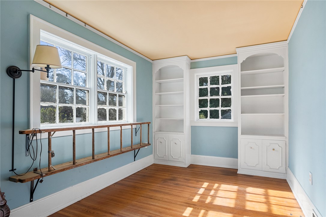2307 North Avenue Anderson, SC 29625 - Photo 11 of 49 This bright space features built-in bookcases, inviting natural light, and classic hardwood flooring.