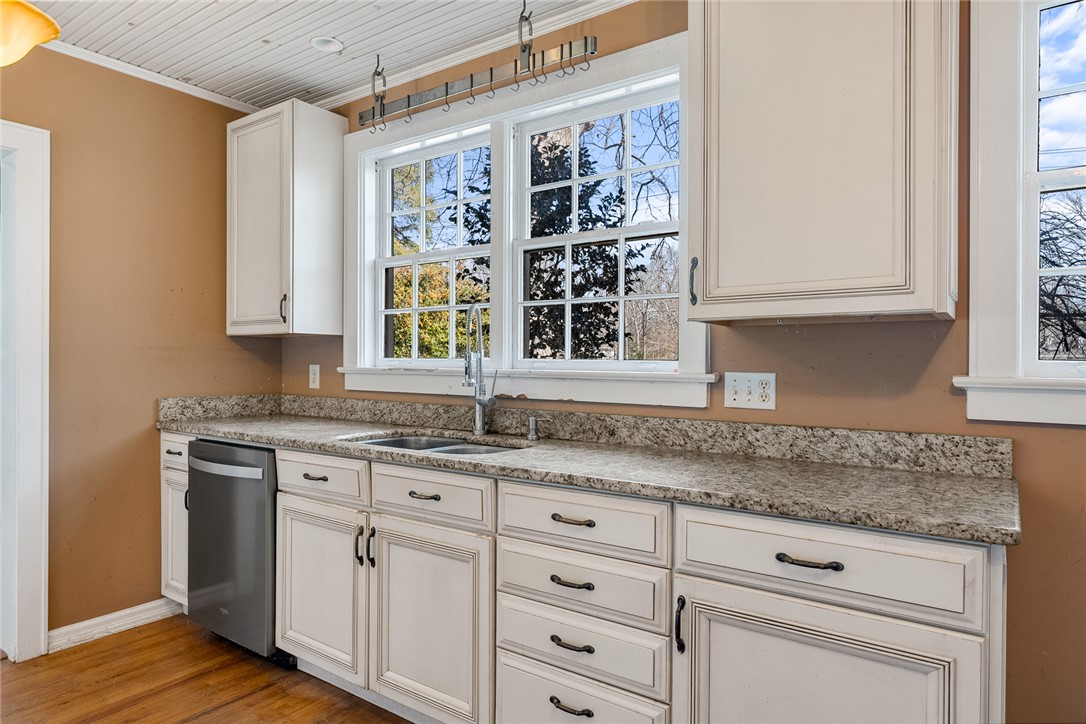 2307 North Avenue Anderson, SC 29625 - Photo 21 of 49 This kitchen features classic cabinetry, granite countertops, and warm hardwood flooring.