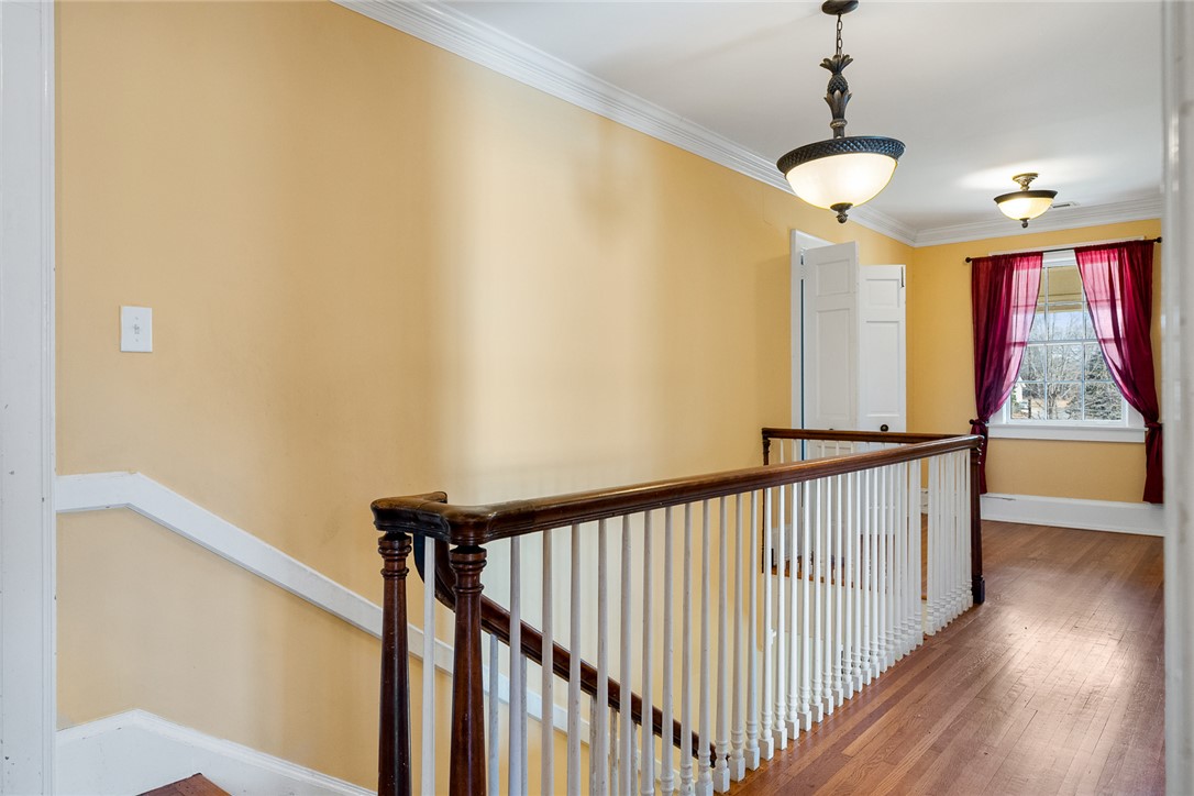 2307 North Avenue Anderson, SC 29625 - Photo 30 of 49 This interior hallway features warm walls, rich wood flooring, and elegant crown molding.