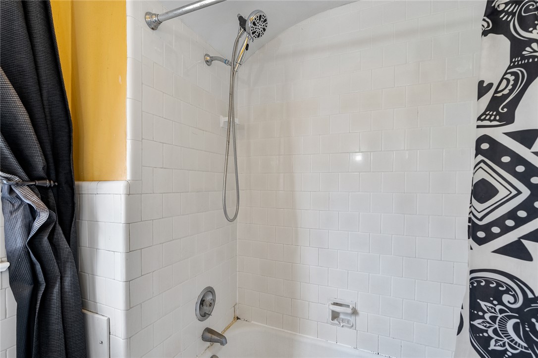 2307 North Avenue Anderson, SC 29625 - Photo 33 of 49 This bathroom features pristine tiled walls and a functional shower with a modern showerhead.