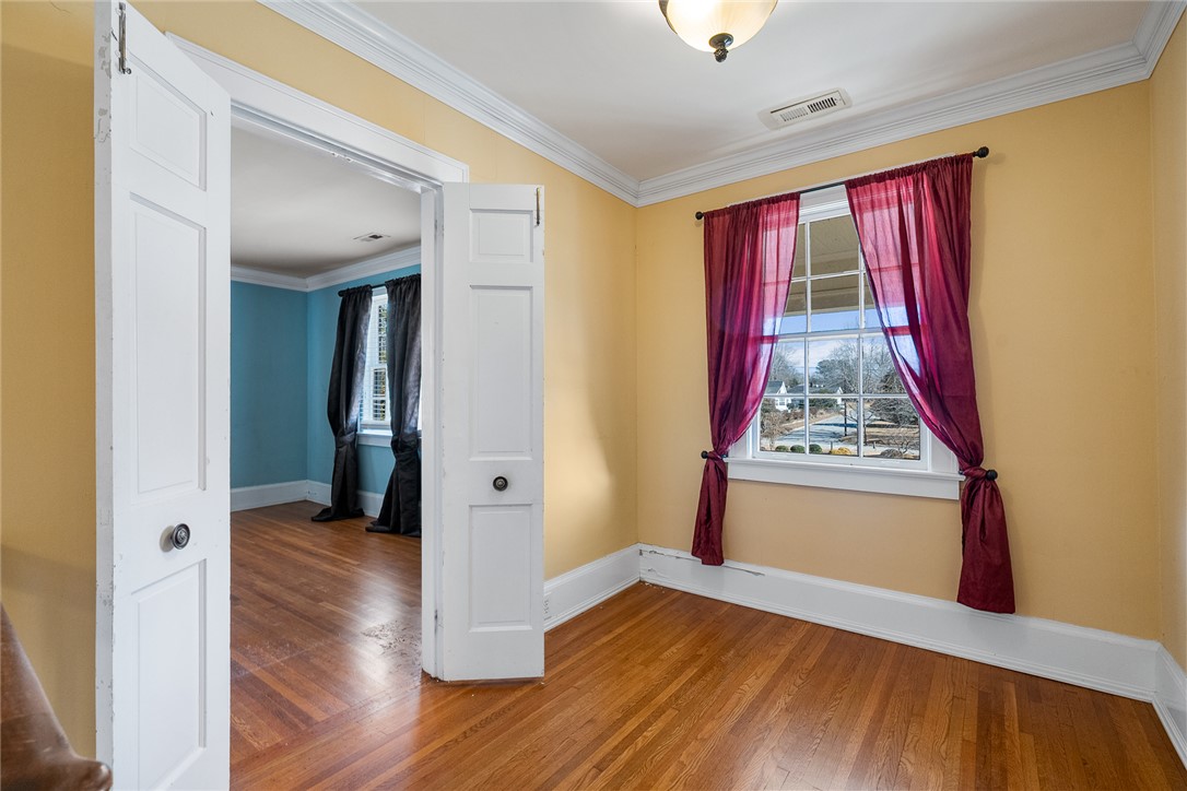 2307 North Avenue Anderson, SC 29625 - Photo 35 of 49 This versatile room features warm hardwood floors and elegant crown molding, ready for your personal touch.