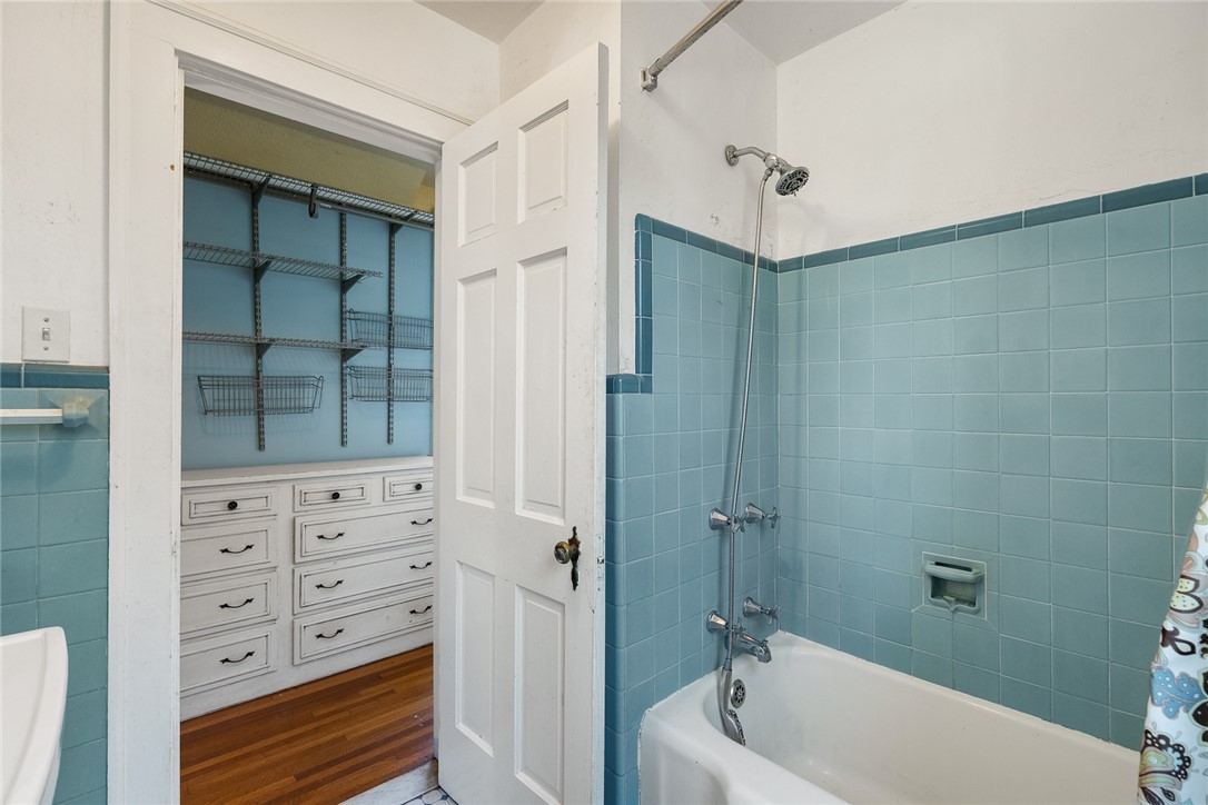 2307 North Avenue Anderson, SC 29625 - Photo 44 of 49 This bathroom showcases vibrant tiled walls and a functional walk-in closet with ample storage.