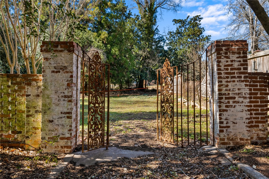 2307 North Avenue Anderson, SC 29625 - Photo 48 of 49 This outdoor entry features brick columns and an ornate wrought iron gate, opening to a private yard.