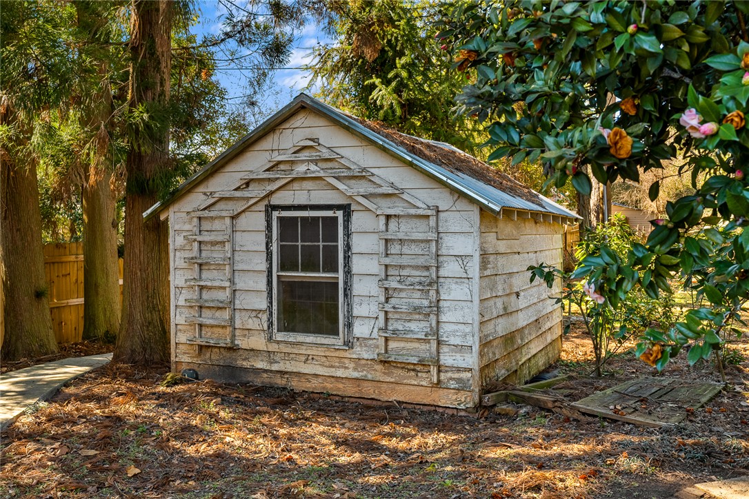 2307 North Avenue Anderson, SC 29625 - Photo 49 of 49 This quaint shed offers versatile storage potential amidst a natural, serene landscape.