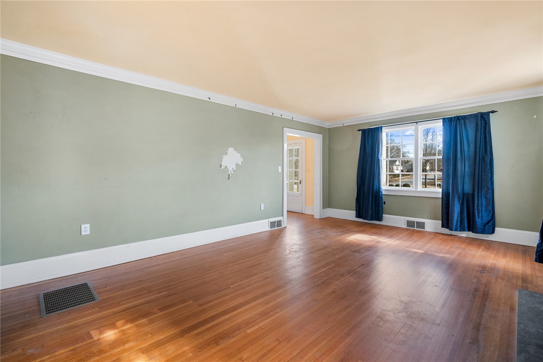 2307 North Avenue Anderson, SC 29625 - Photo 9 of 49 This spacious interior features rich hardwood flooring and classic crown molding, ready for your personal touch.