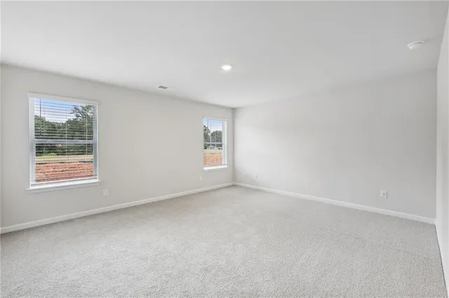 an empty room with a bathroom and a sink