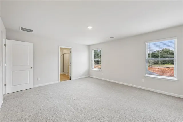 a bathroom with a granite countertop sink a toilet and shower