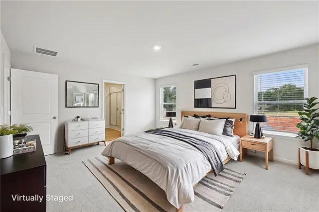 a spacious bathroom with a double vanity sink a mirror and a shower