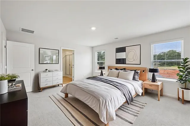 a spacious bathroom with a tub sink shower and two mirror
