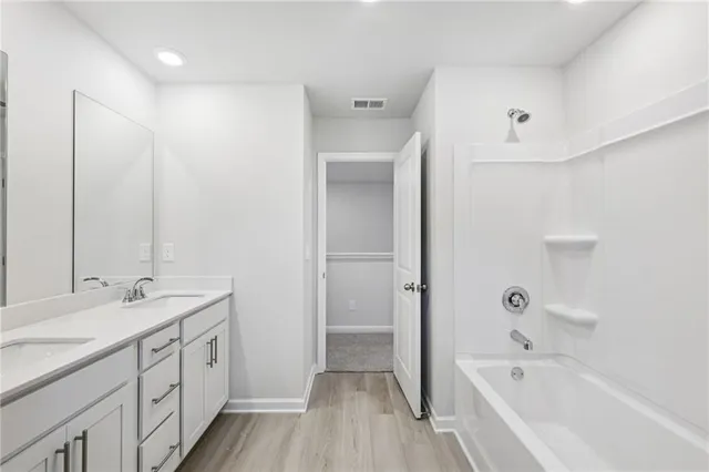 a bathroom with a double vanity sink and a mirror
