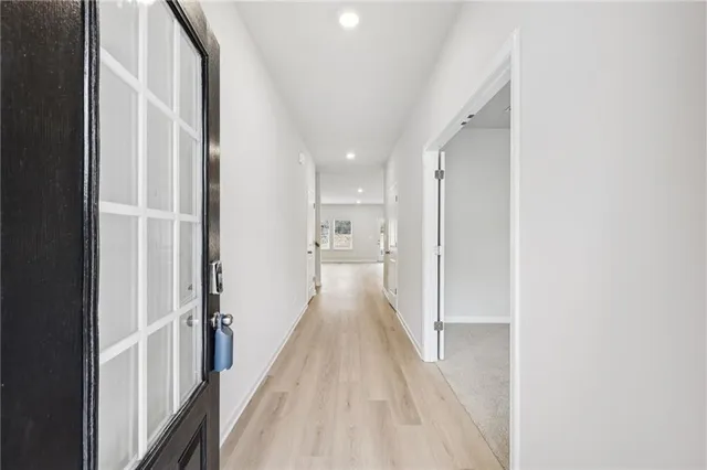 a view of kitchen with stainless steel appliances refrigerator stove microwave and cabinets