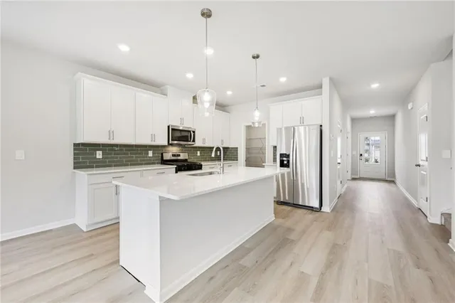 a view of an empty room with a window and fireplace