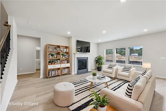 a view of kitchen with kitchen island stainless steel appliances refrigerator stove microwave and cabinets