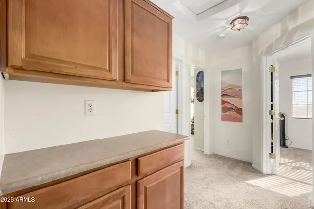 a kitchen with granite countertop cabinets and white appliances