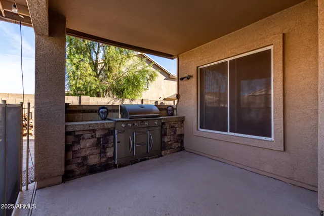 a view of a patio with a table and chairs