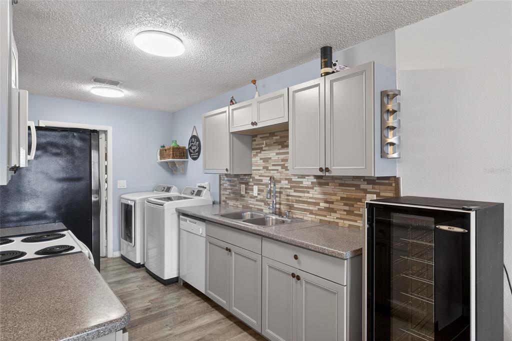 622 Ridge Terrace Winter Haven, FL 33881 - Photo 9 of 29 a kitchen with stainless steel appliances a sink stove and refrigerator