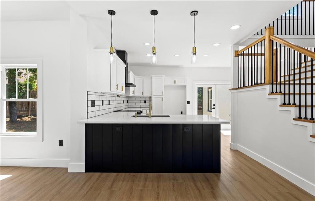 525 Medlock Road Decatur, GA 30030 - Photo 11 of 50 a kitchen with stainless steel appliances granite countertop a sink a stove and a wooden floor