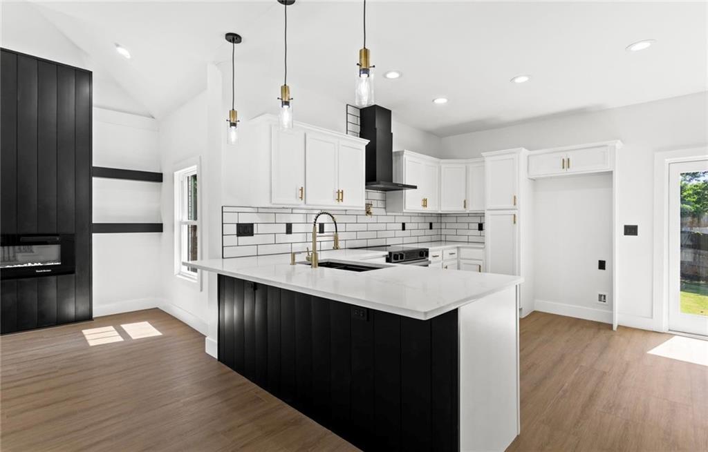 525 Medlock Road Decatur, GA 30030 - Photo 12 of 50 a kitchen with kitchen island a sink stainless steel appliances and wooden floor