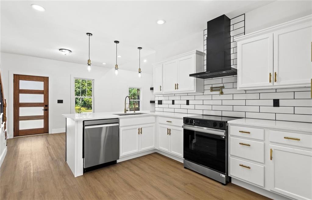 525 Medlock Road Decatur, GA 30030 - Photo 16 of 50 a kitchen with stainless steel appliances granite countertop a sink a stove and a wooden floors