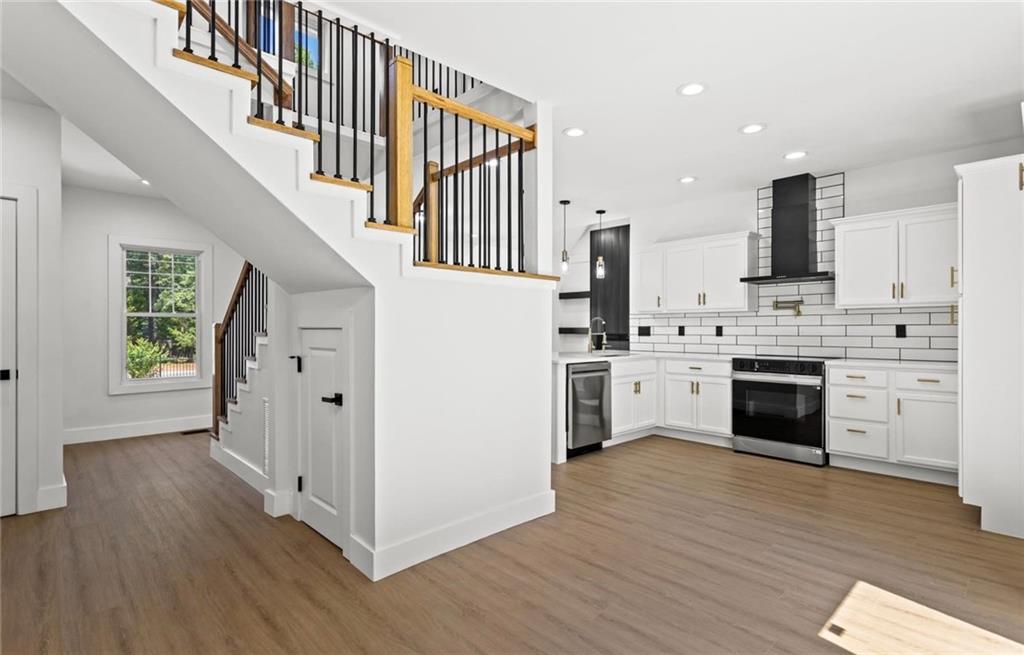 525 Medlock Road Decatur, GA 30030 - Photo 17 of 50 a kitchen with cabinets stainless steel appliances and wooden floor