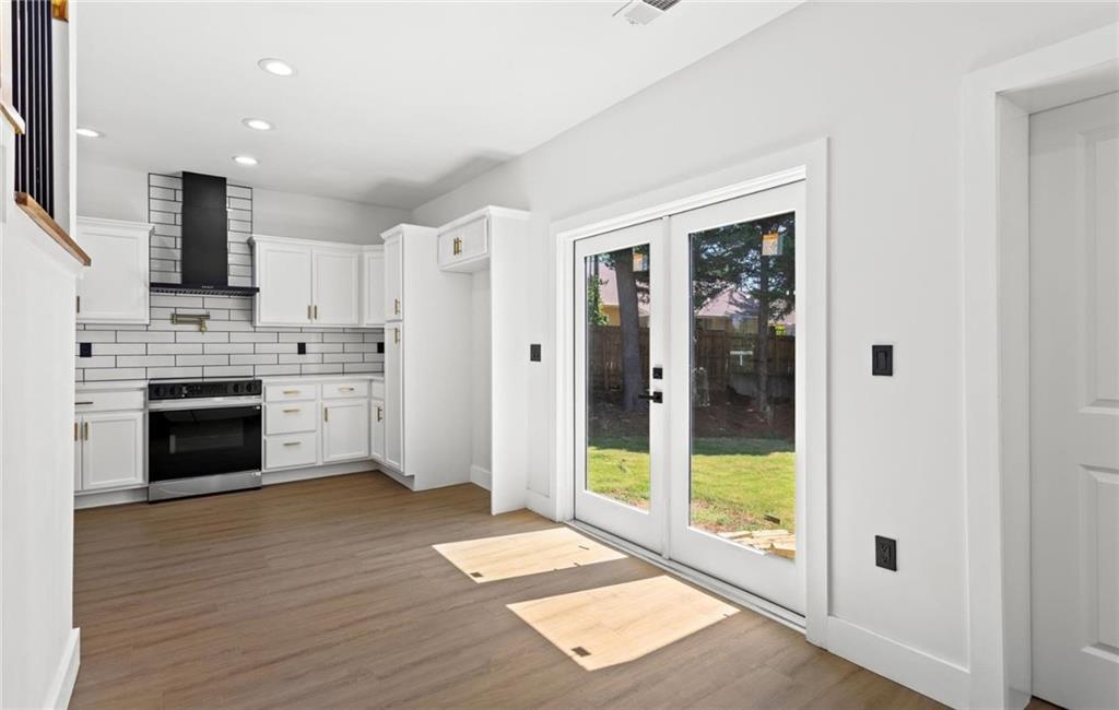 525 Medlock Road Decatur, GA 30030 - Photo 18 of 50 a open kitchen with stainless steel appliances granite countertop a stove and a refrigerator