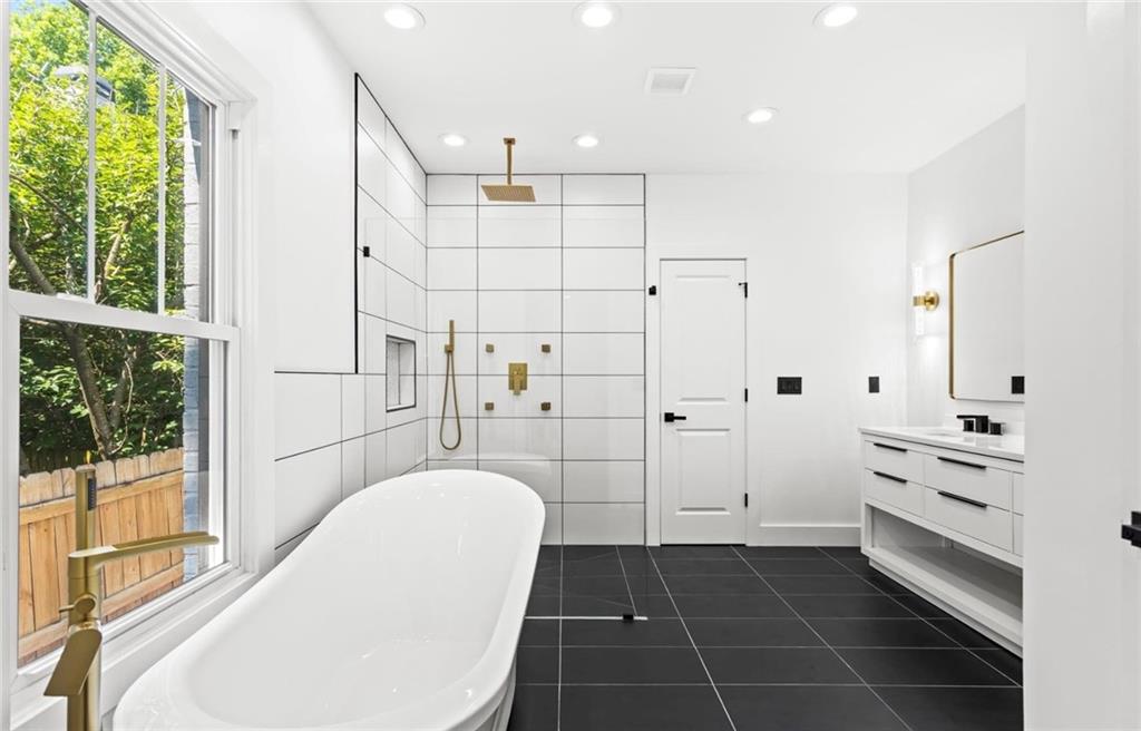 525 Medlock Road Decatur, GA 30030 - Photo 24 of 50 a bathroom with a bathtub and a shower