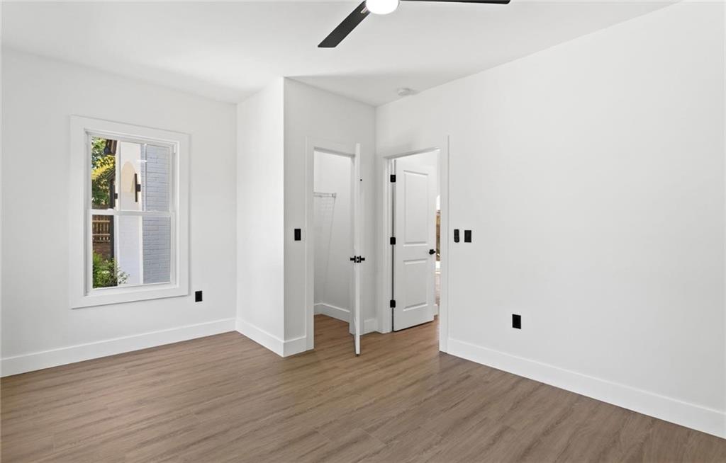 525 Medlock Road Decatur, GA 30030 - Photo 32 of 50 an empty room with wooden floor and windows