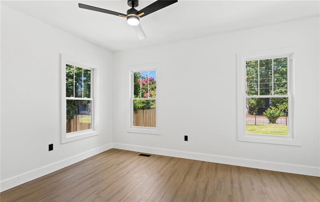 525 Medlock Road Decatur, GA 30030 - Photo 33 of 50 a view of an empty room with wooden floor and a window