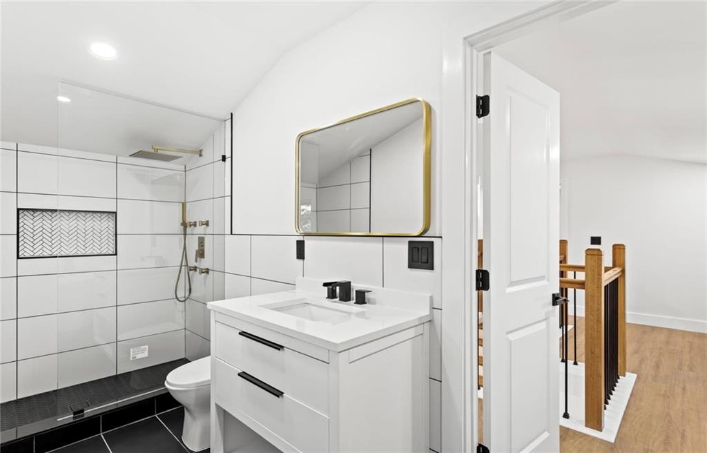 525 Medlock Road Decatur, GA 30030 - Photo 41 of 50 a bathroom with a sink toilet and mirror