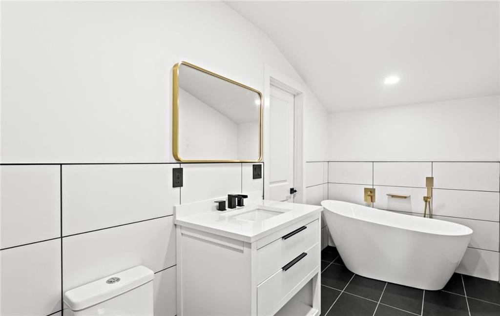 525 Medlock Road Decatur, GA 30030 - Photo 44 of 50 a bathroom with a sink and a mirror