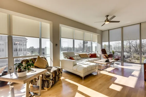 a bedroom with furniture and large windows